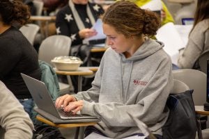 A student types on her computer during Visner's STIA 391 class.
