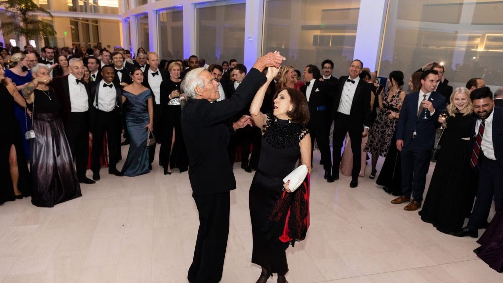 Dean Hellman, in dark formalwear, dancing at gala.