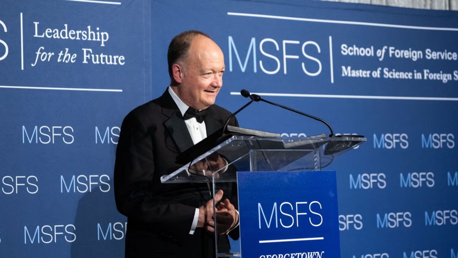President DeGioia, wearing black formalwear, standing at podium during gala.