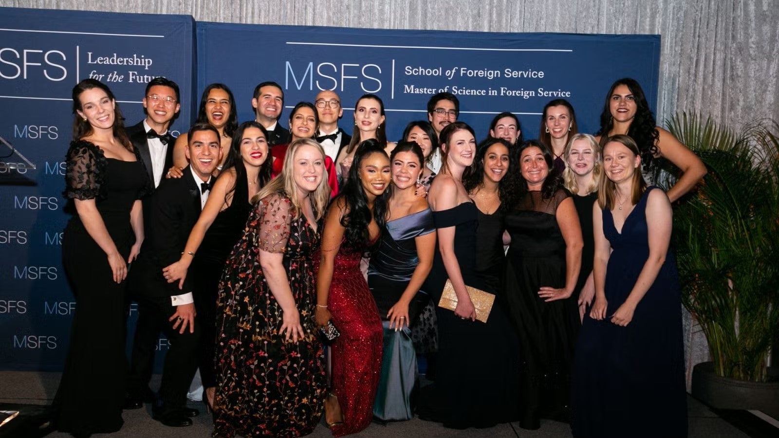 Large group of students, in formalwear, gathered together at gala.