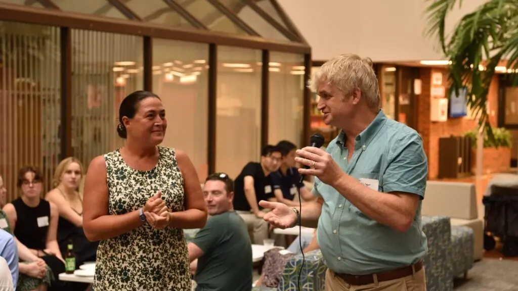 Two alumni talking at a reception.