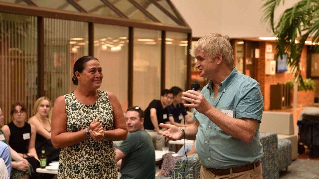 Two alumni talking at a reception.