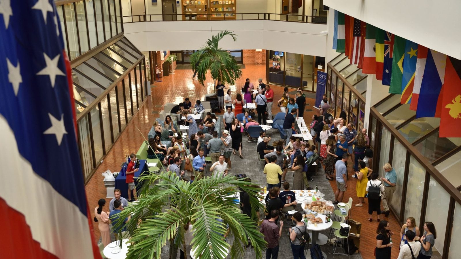 A view of a large reception of people from above.