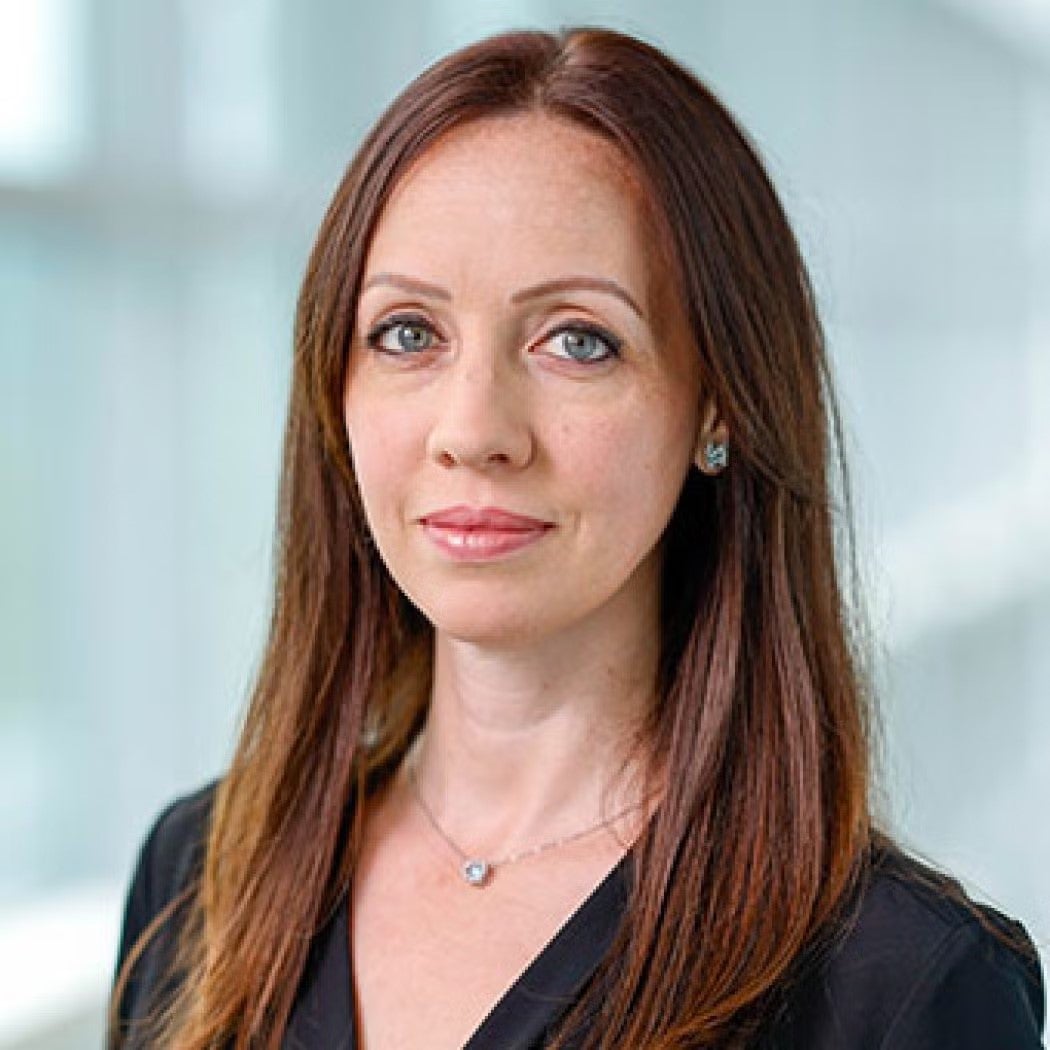 Headshot of Renanah Joyce, wearing a black blazer.