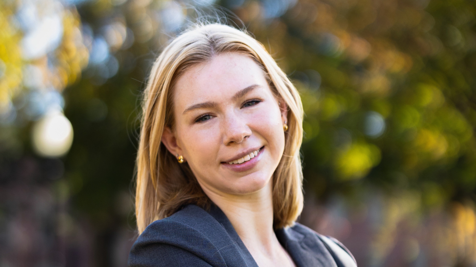 A blonde woman wearing a black suit.