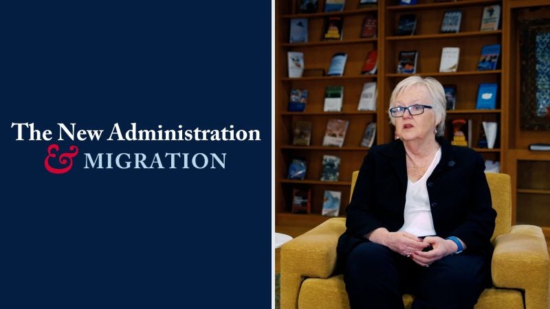 &quot;The New Administration &amp; Migration.&quot; Photo of Beth Ferris sitting in a library setting.