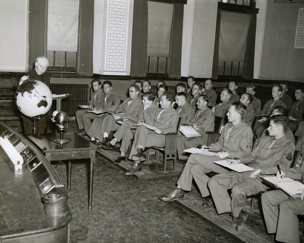 Father Walsh teaches a classroom full of uniformed men