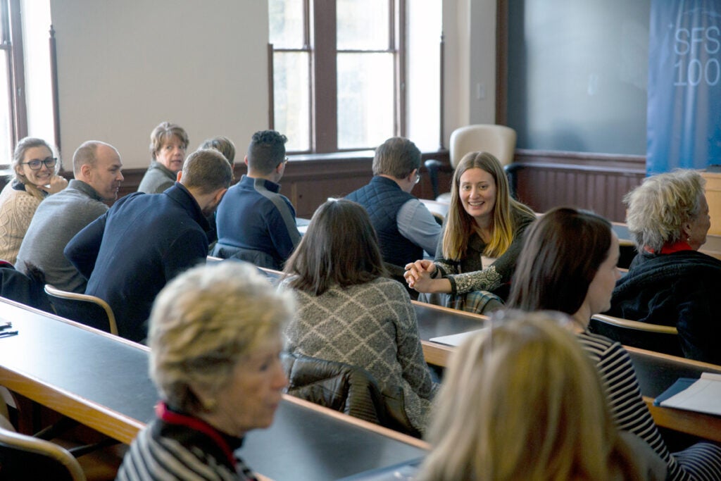 Professionals speaking to each other in a classroom setting