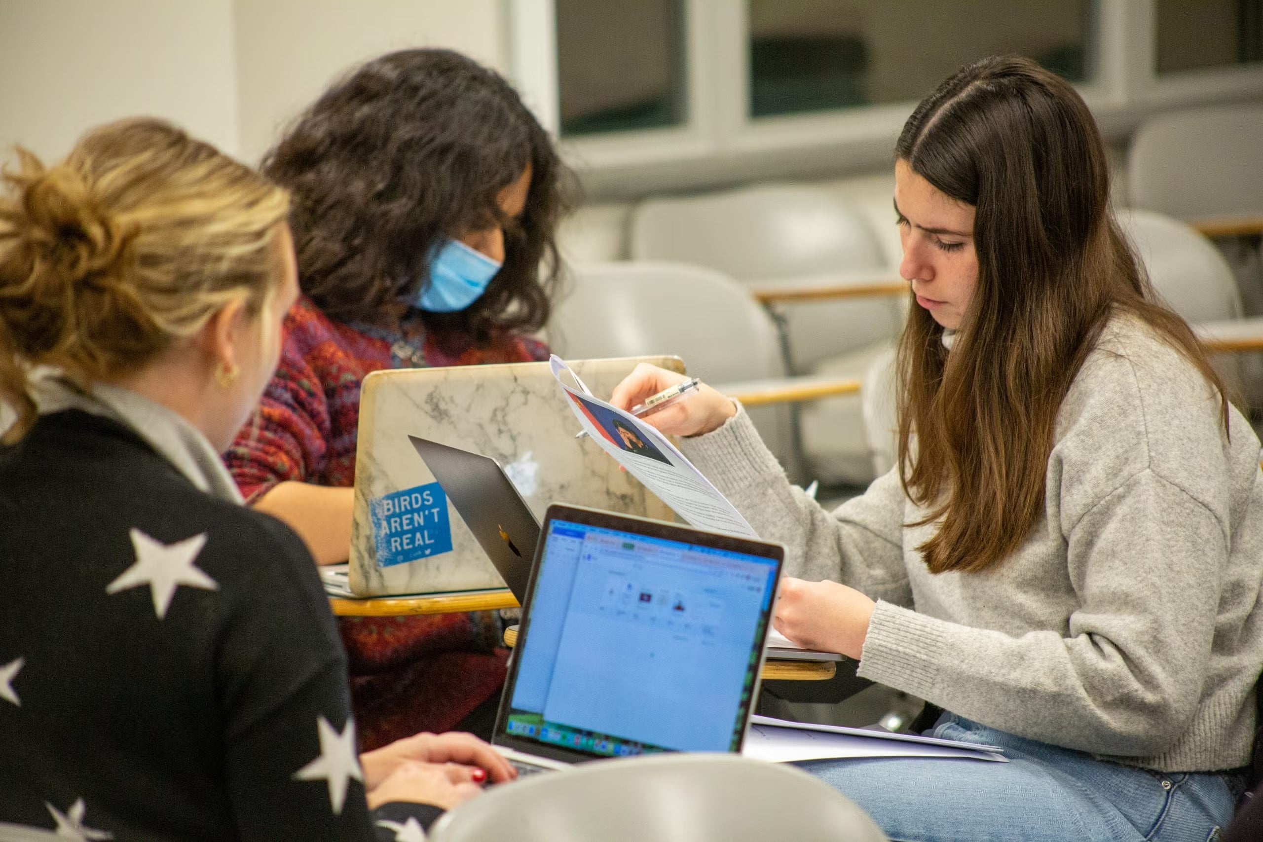 Two students collaborate while seated at their desks during Visner's STIA 391 class.