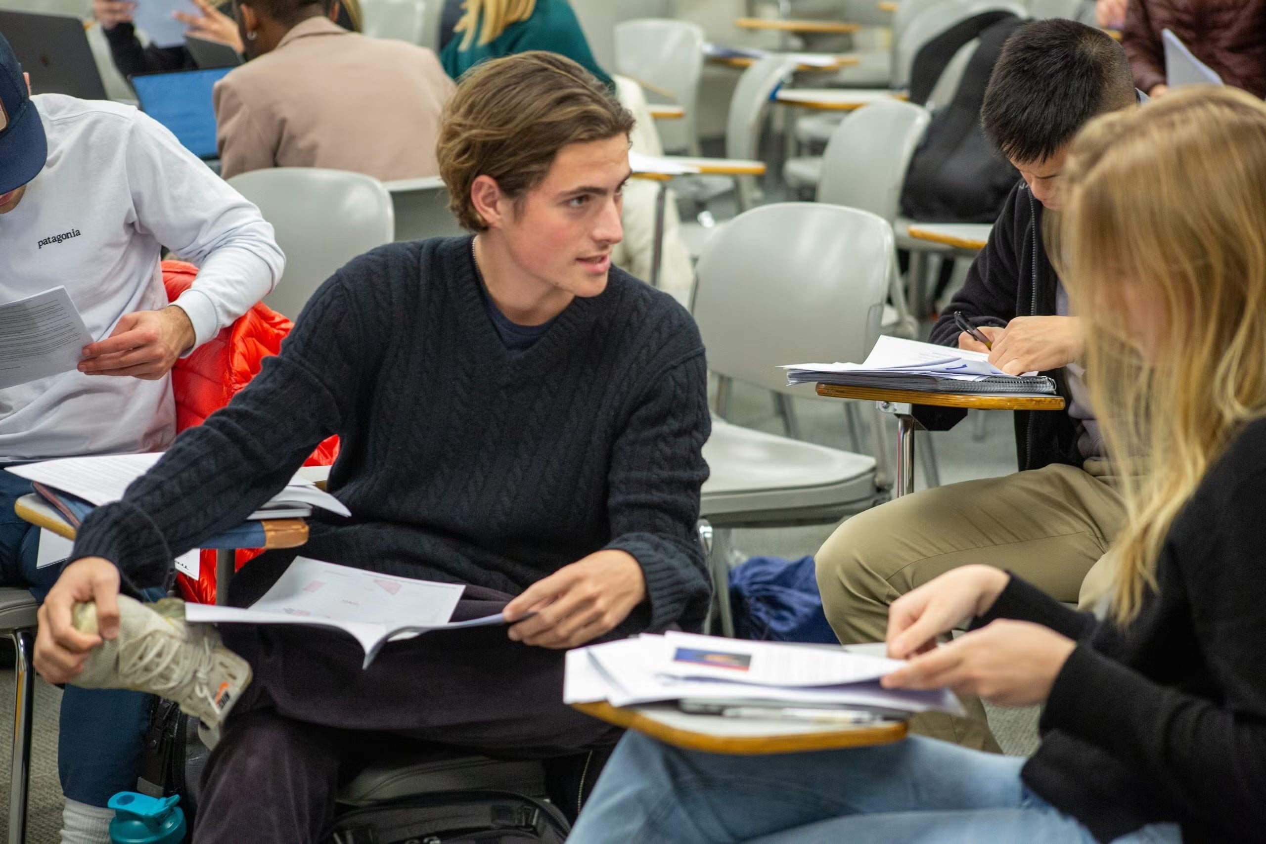 Two students converse while seated during Visner's STIA 391 class.