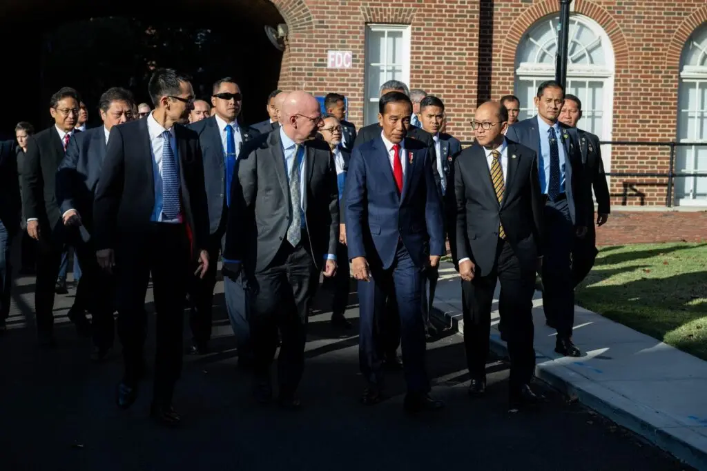 Joel Hellman, President Joko Widodo, and others walking outside New North.