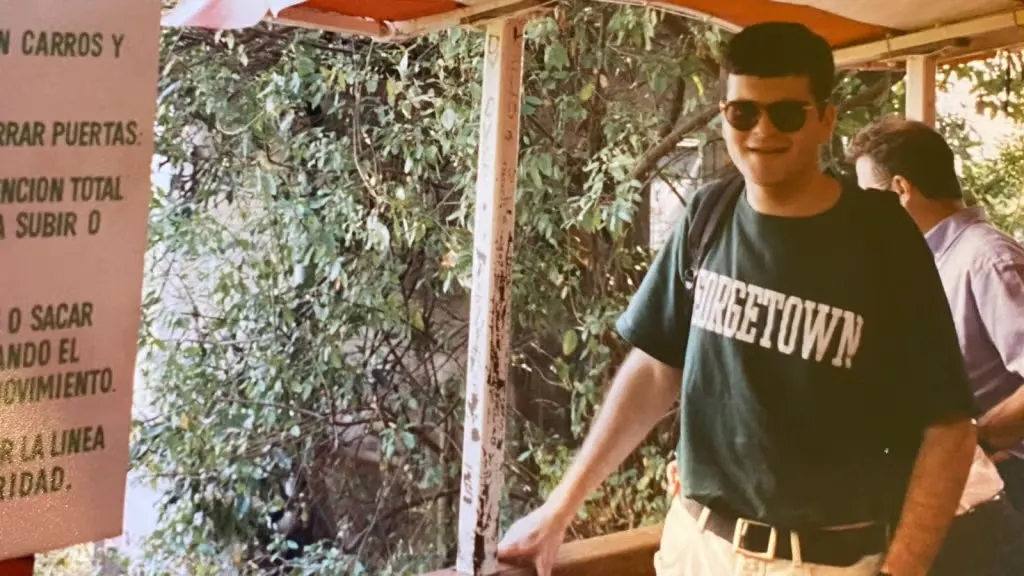 Deputy Chief of Mission Richard Michaels standing in a Chile forest with a Georgetown shirt.