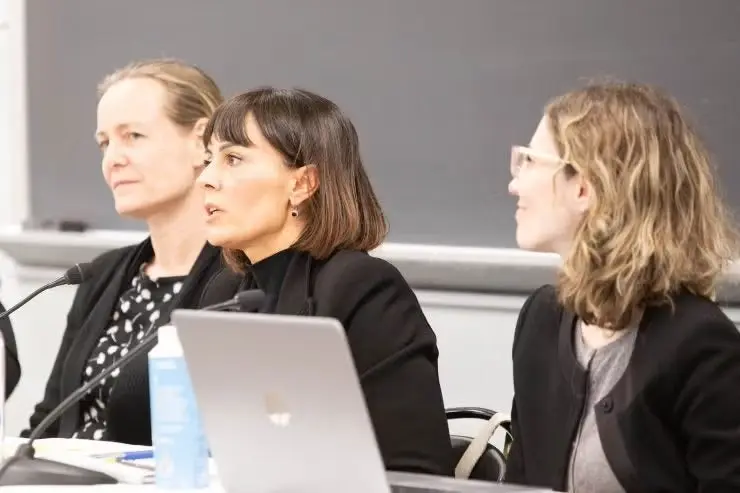 Three women in dark suits speaking at a Georgetown Law event.
