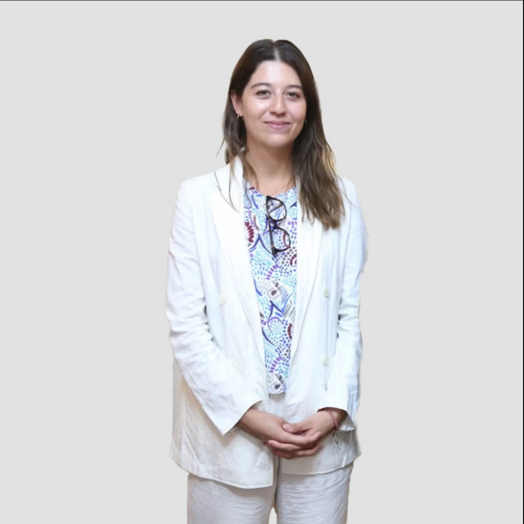 Héloïse Wiart wearing a white suit and a floral shirt.