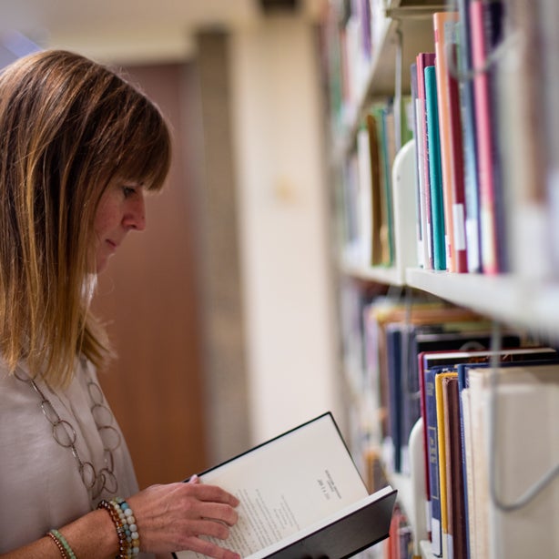 Woman in the library browsing a book