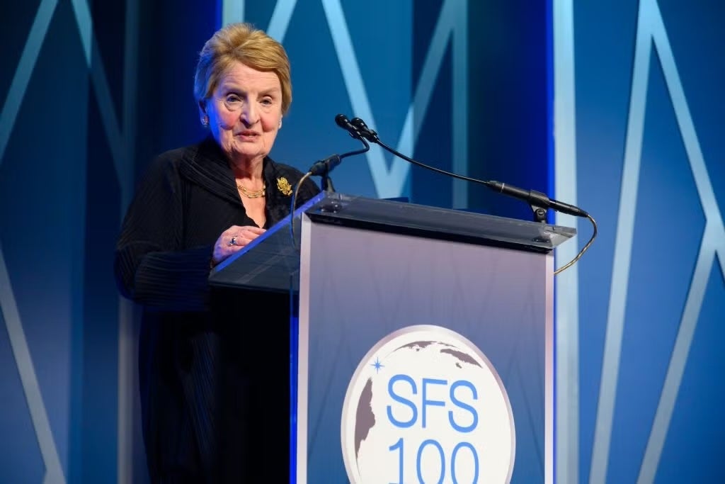 Madeleine Albright speaking in front of a podium