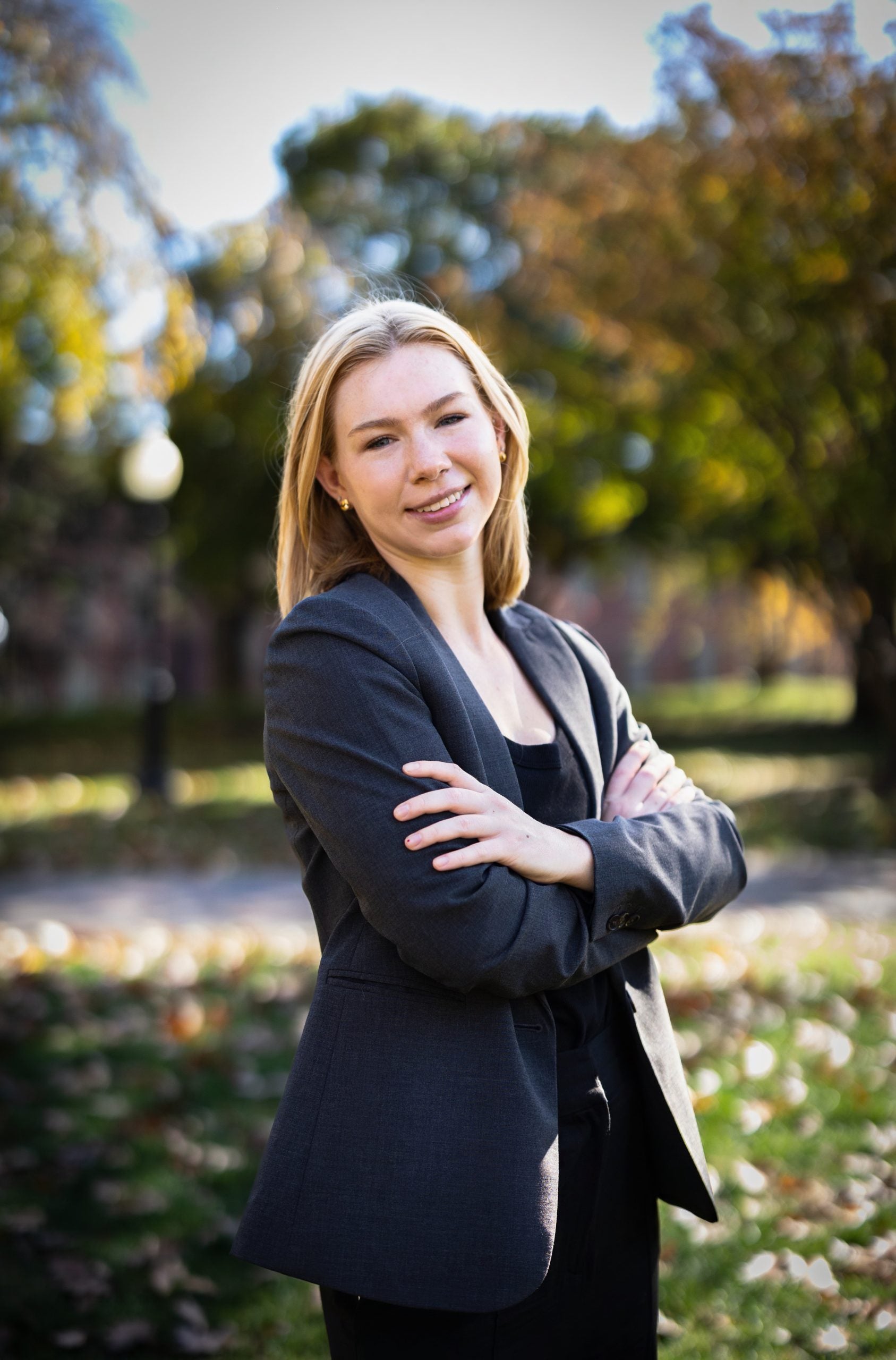 vertical image of Paige Maylath, who is a blond woman in a black suit.