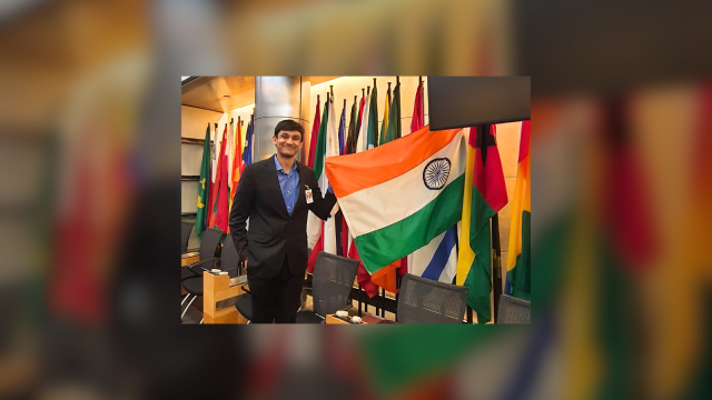 Pranav Agarwal (MSFS&#039;25) holds the Indian flag.