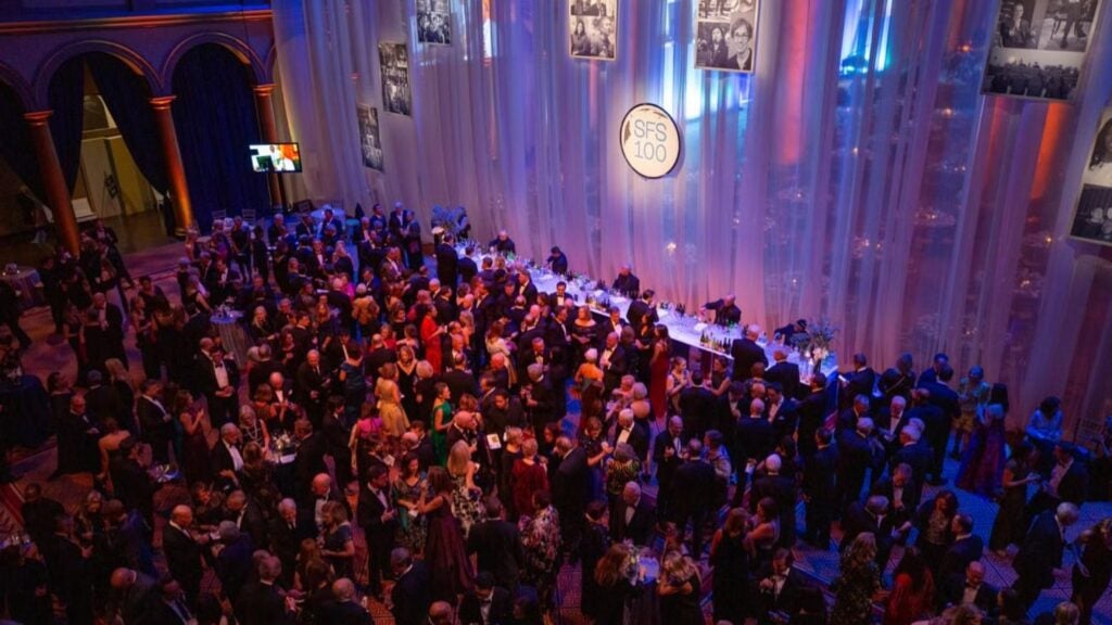 A large crowd of people in formal attire at the SFS Centennial celebration.