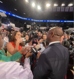 Journalists interviewing a participant at a CNN Presidential Debate event.