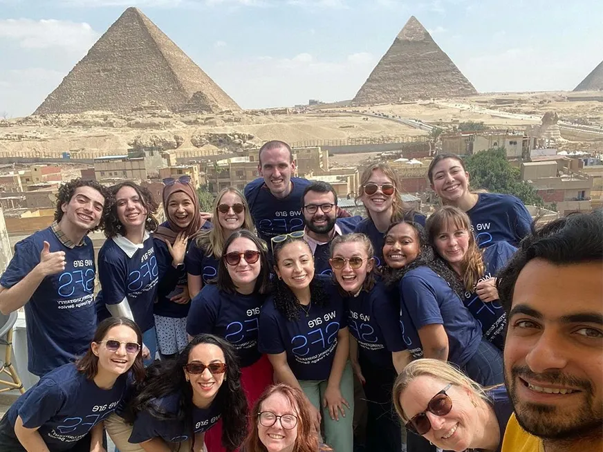 Group of SFS students taking a selfie in front of the pyramids in Egypt.