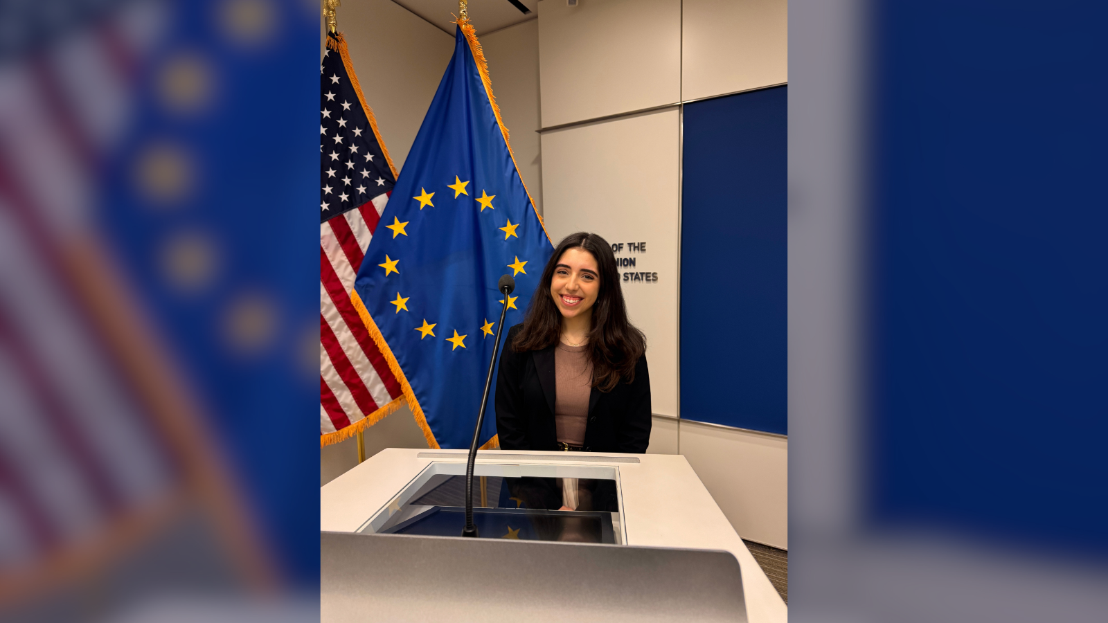 Sophia Athan in front of EU and U.S. flags