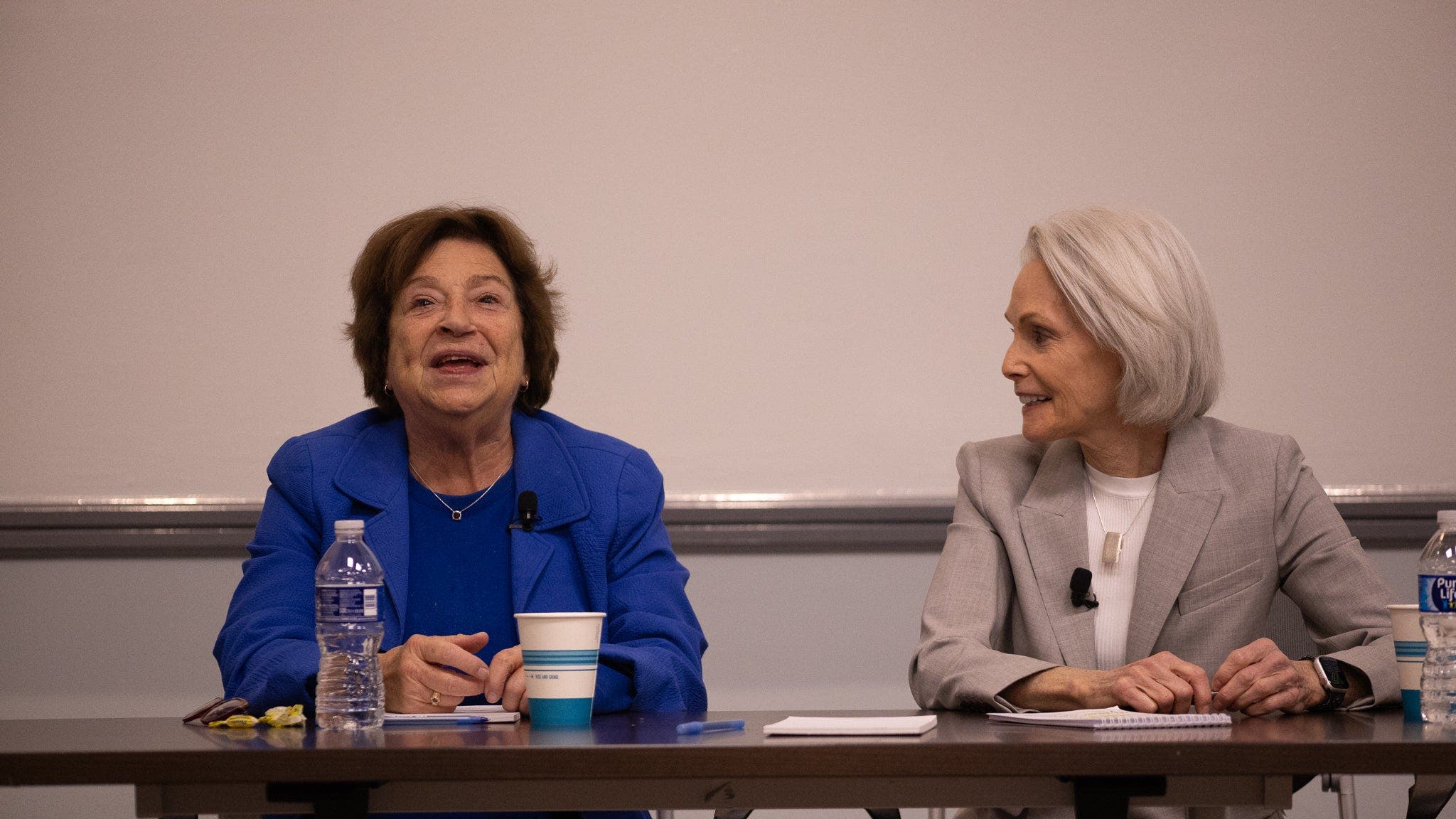 SFS Professor Emerita Angela Stent and Adjunct Professor Jill Dougherty sit at a table.