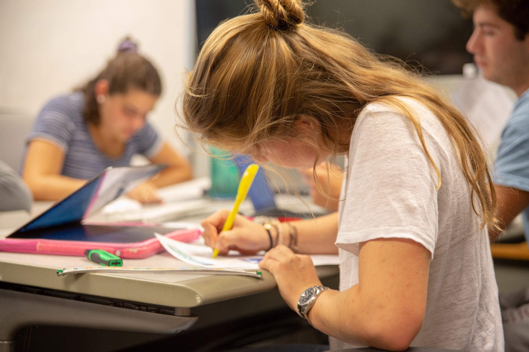 Student highlighting paper