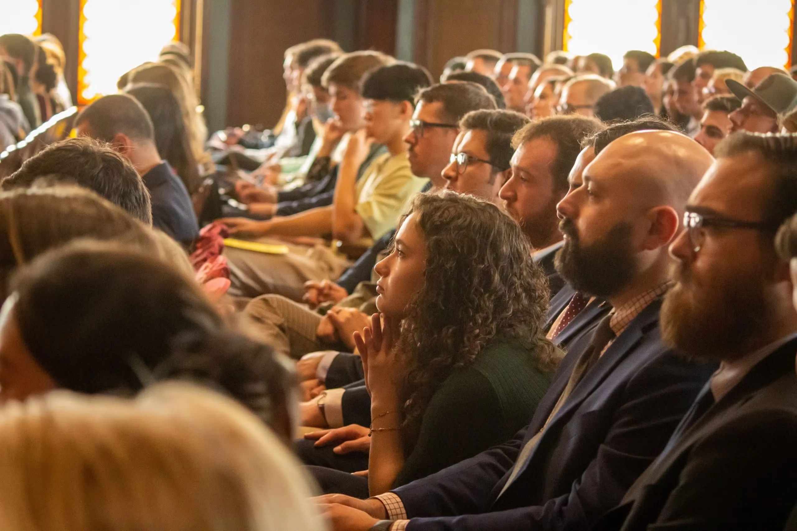 Audience members listen intently as Sullivan speaks during his remarks.