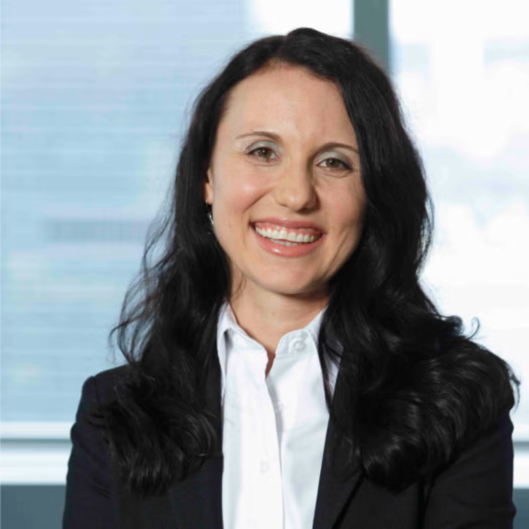 Reneta Kugele wearing a dark blazer and a white button down shirt.