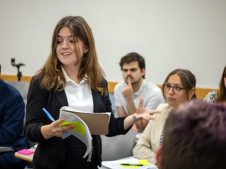 student presenting in class in front of classmates