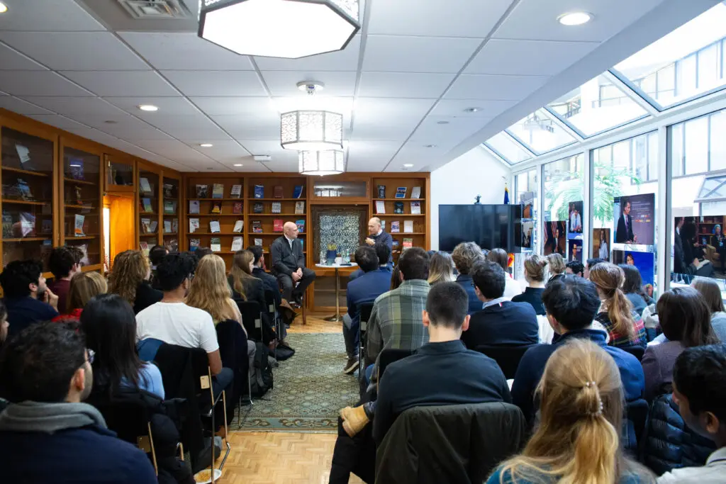 Rows of students sit in McGhee Library for a Dean's Coffee Chat with Dean Joel Hellman and former Italian Prime Minister Enrico Letta.