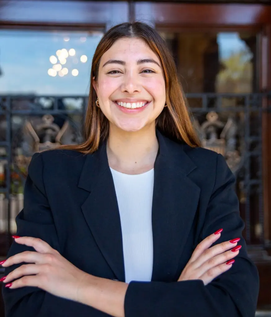 Andrea Nucete Alvarado wearing a navy blue blazer and white blouse.