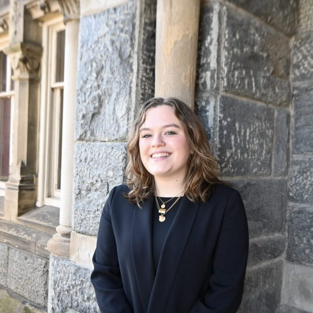 Allie Farber wearing a black blazer and a black shirt.