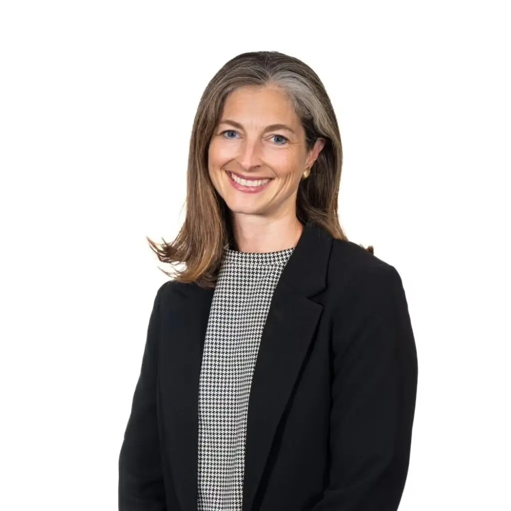 Allison Jenkins wearing a houndstooth shirt and a black blazer.