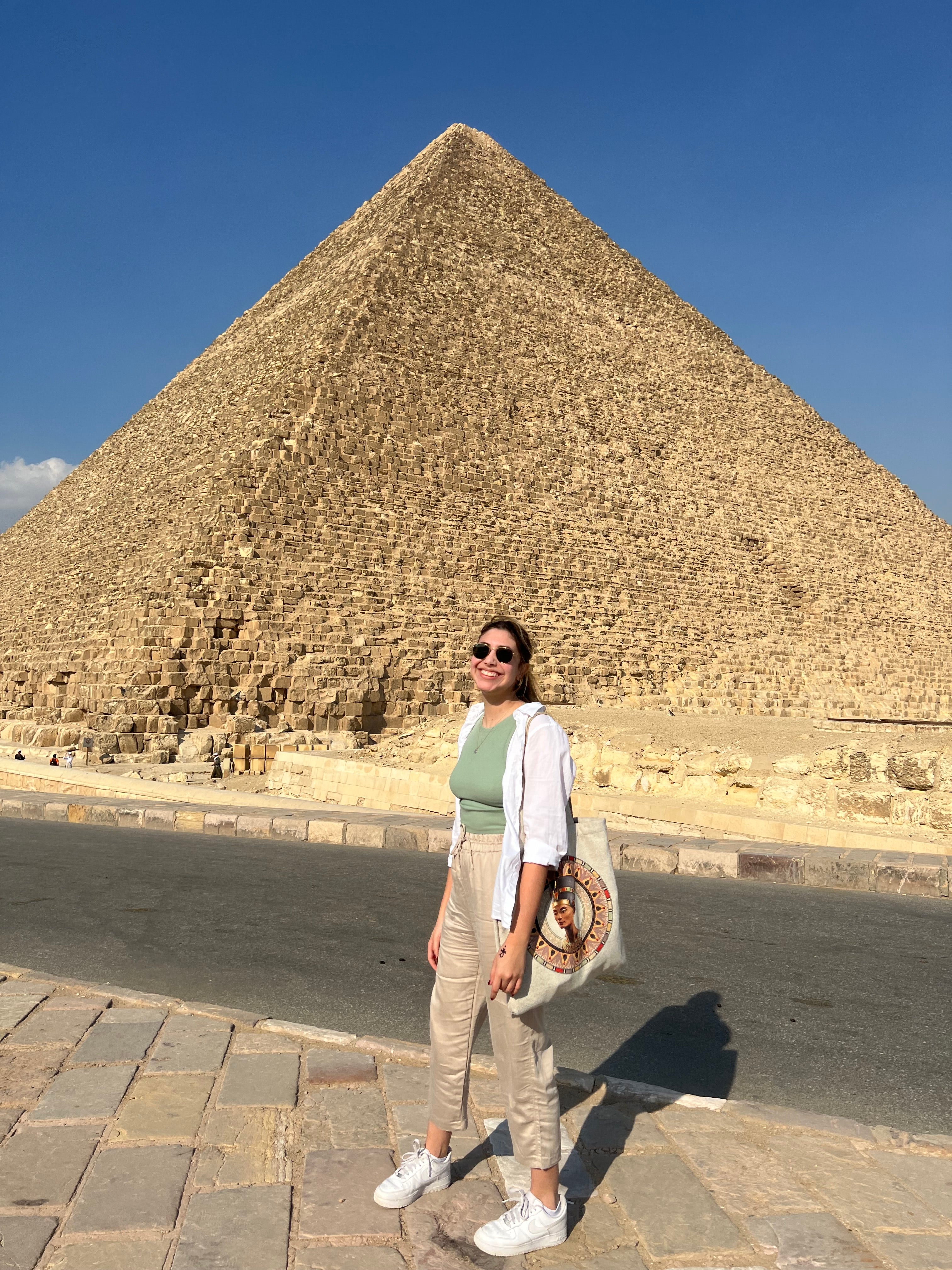 Andrea Nucete stands in front of a pyramid.