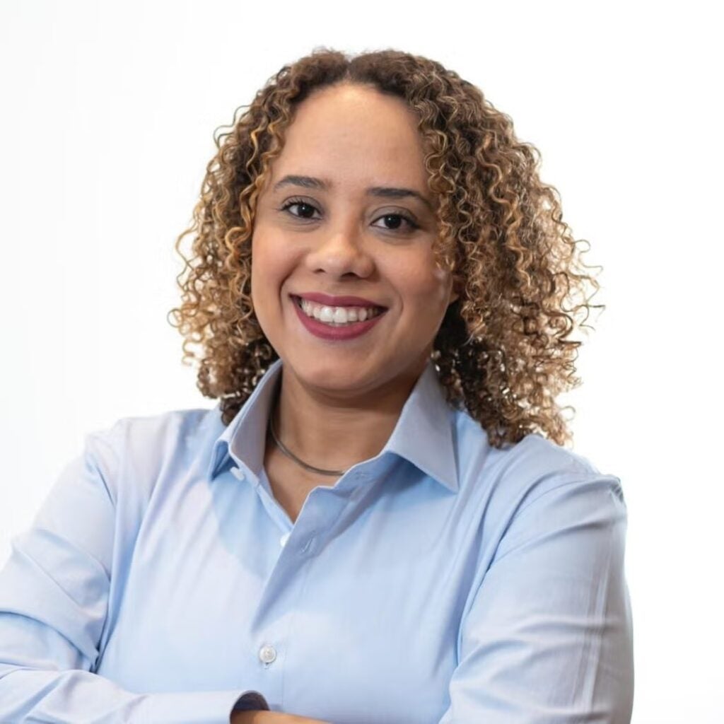 Barbara Ferreira Santos wearing a light blue button-down shirt.