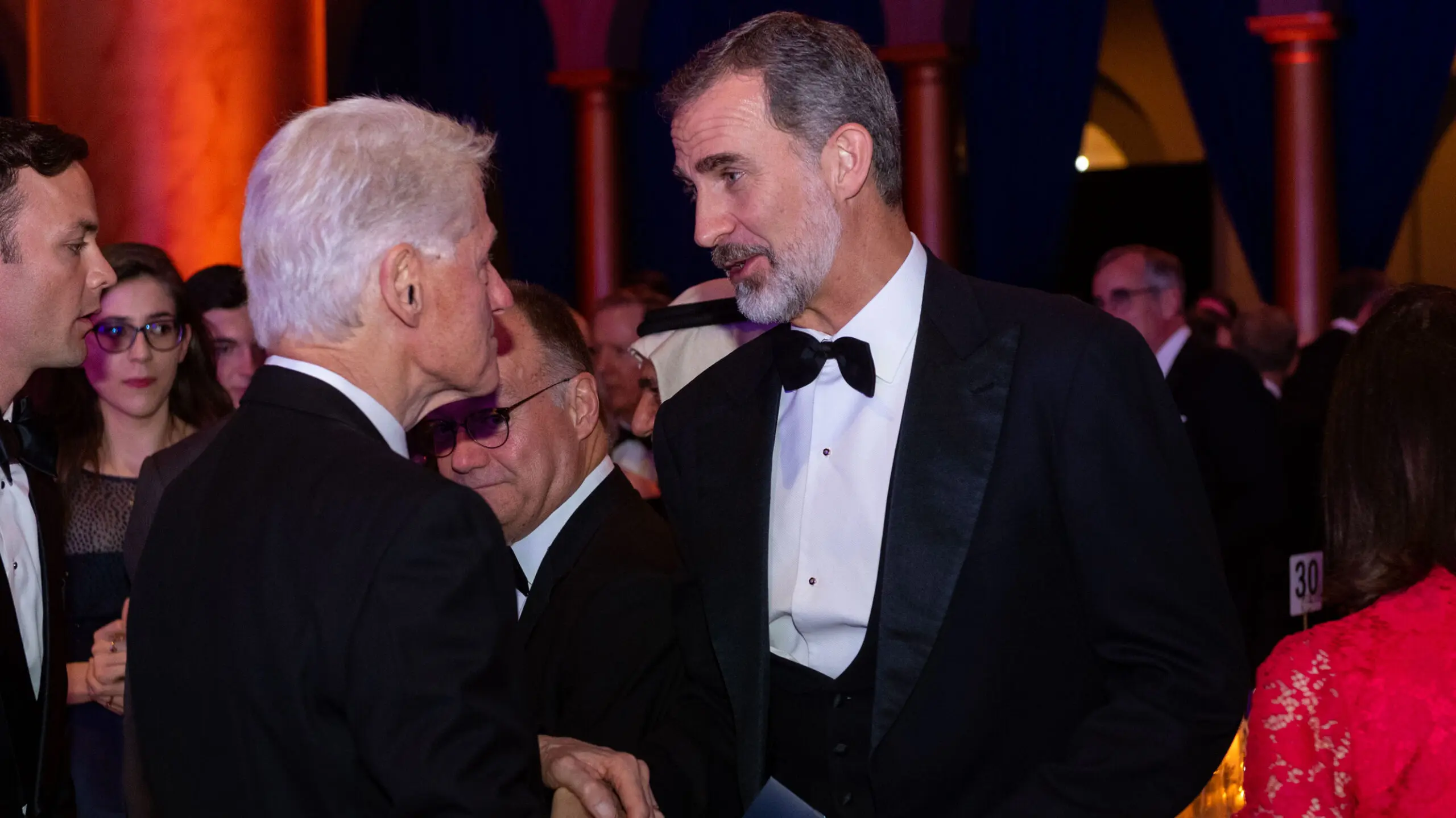 Bill Clinton and King Felipe VI of Spain shaking hands in the SFS Centennial Gala