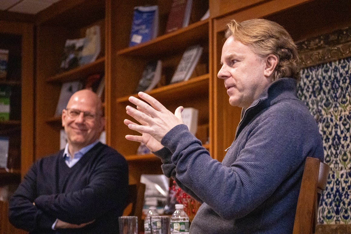 Dean Hellman engaging in conversation with Justin Smith.