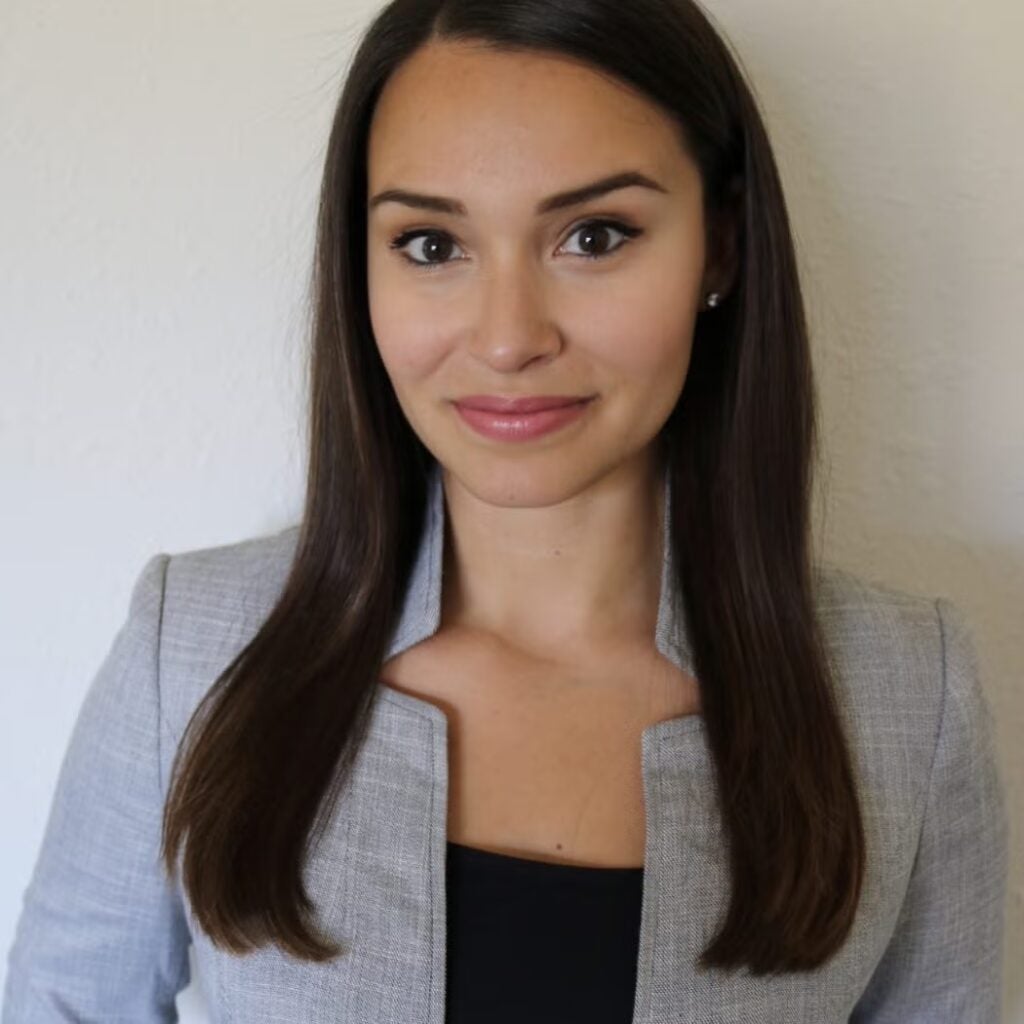 Demi McKnight wearing a gray blazer and a black shirt