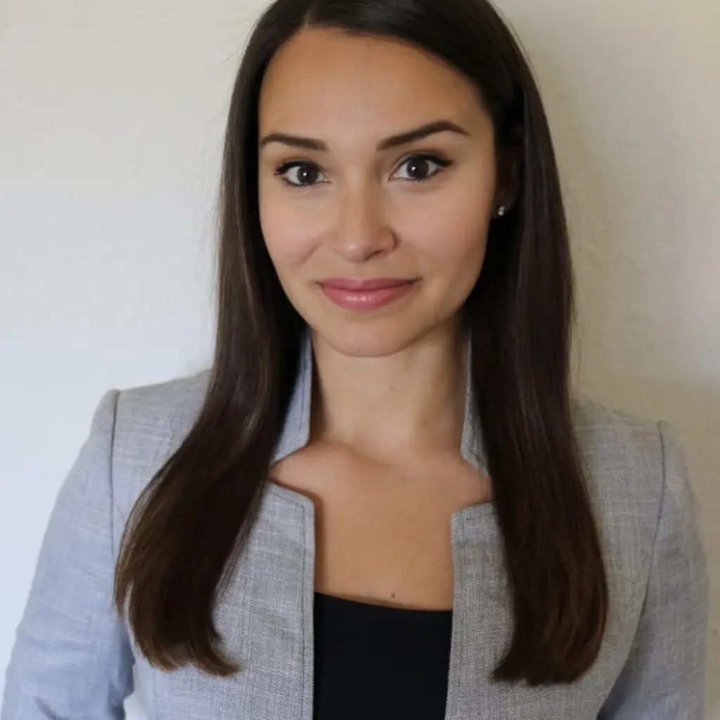 Demi McKnight wearing a gray blazer and a black shirt