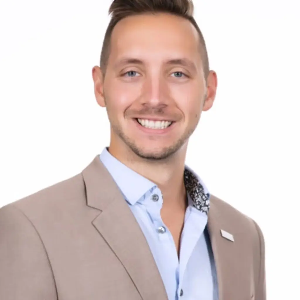 Doug Umberger wearing a tan blazer and a light blue button down shirt.
