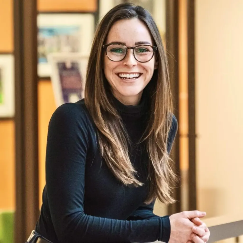 Emily Friedman wearing a black shirt and glasses.