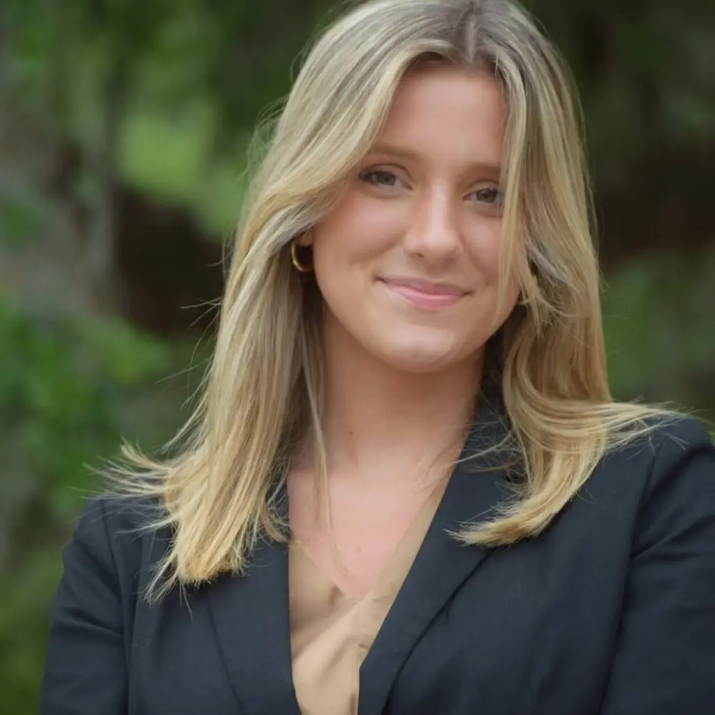 Estelle Erwich wearing a dark blazer with a cream blouse.