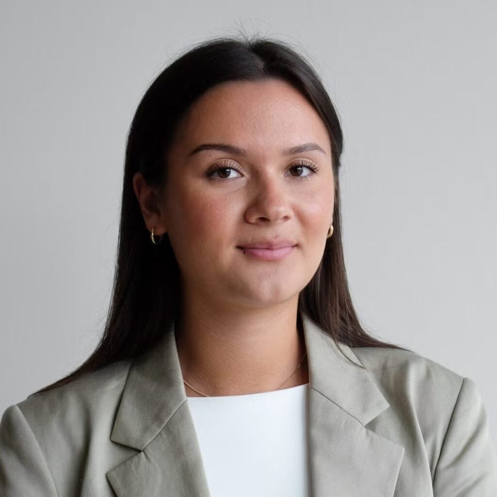 Esther Serger wearing a beige blazer and white blouse.