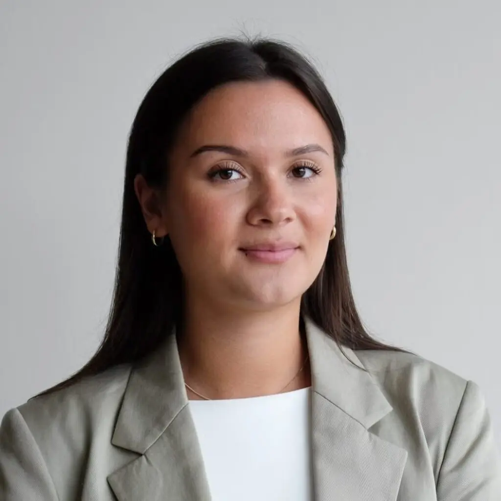 Esther Serger wearing a beige blazer and white blouse.