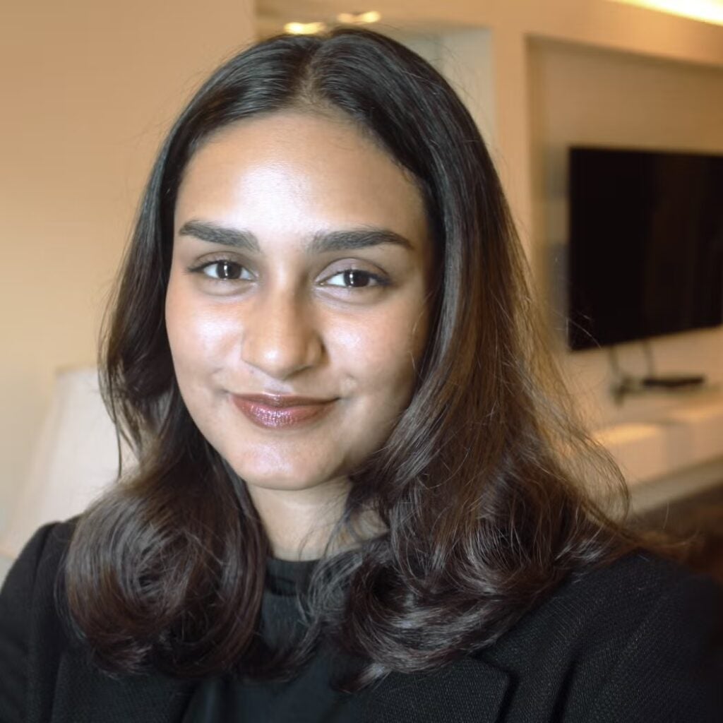 Fathima Naureen Fathahudeen wearing a black blazer and a black shirt.