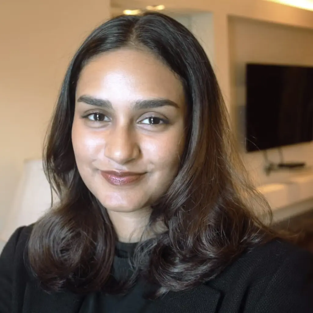 Fathima Naureen Fathahudeen wearing a black blazer and a black shirt.