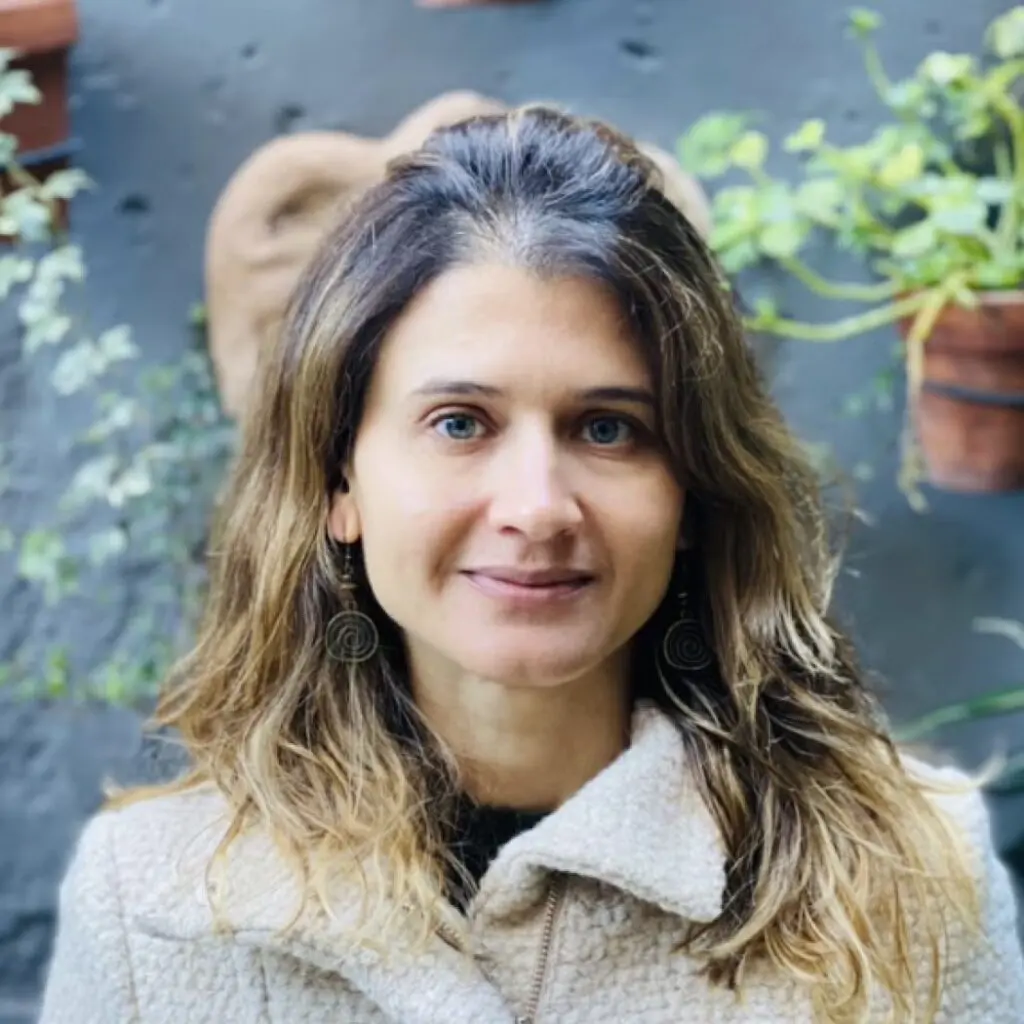 Flavia Carbonari wearing a tan jacket.