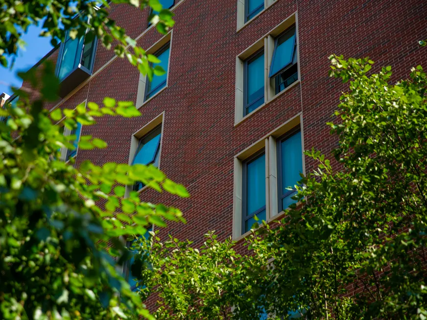 Exterior of Georgetown dorm rooms. A building featuring brick walls, and windows.